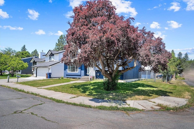 4129 E 32nd Ave, Spokane, WA 99223 - view of property hidden behind natural elements featuring an attached garage and driveway