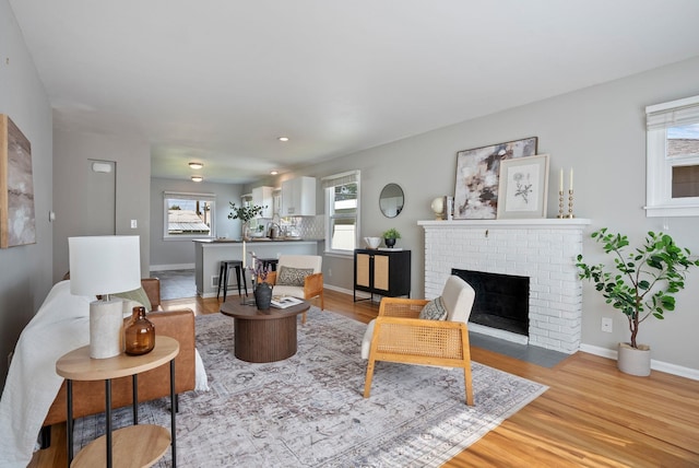 5204 N Maple St, Spokane, WA 99205 - living room featuring light wood-type flooring and a fireplace