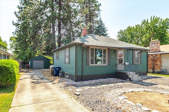 3829 W Broad Ave, Spokane, WA 99205 - view of front of home featuring a chimney, driveway, a detached garage, and an outdoor structure