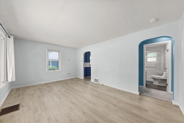 3829 W Broad Ave, Spokane, WA 99205 - spare room featuring arched walkways, light wood finished floors, and a smoke detector