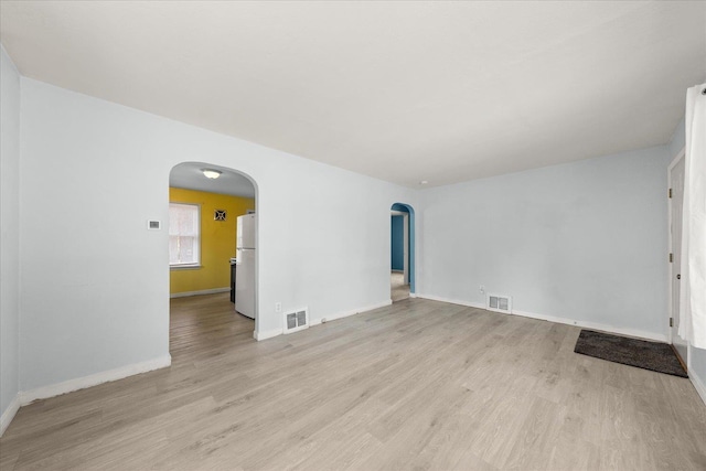 3829 W Broad Ave, Spokane, WA 99205 - unfurnished room with arched walkways and light wood-type flooring