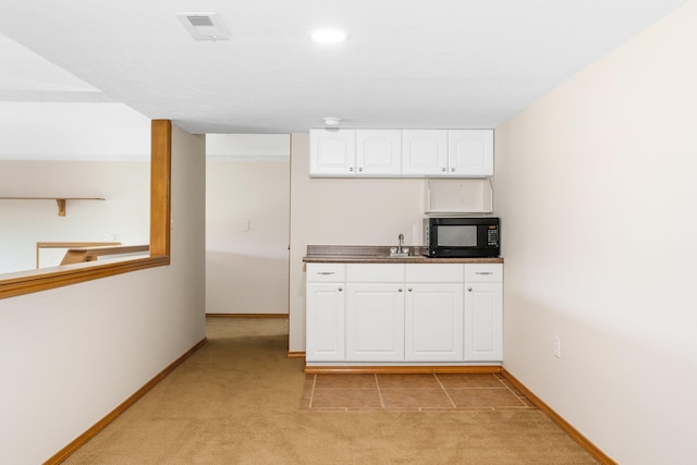 2106 E Turnberry Ln, Spokane, WA 99223 - kitchen with black microwave, light carpet, white cabinetry, dark countertops, and recessed lighting