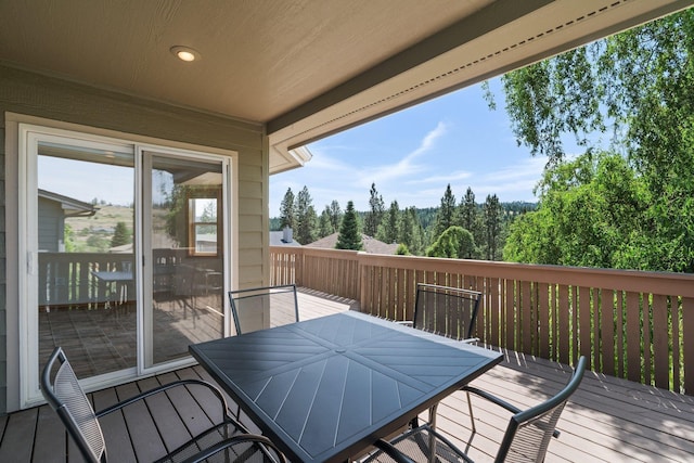 2106 E Turnberry Ln, Spokane, WA 99223 - wooden terrace featuring outdoor dining area and a view of trees