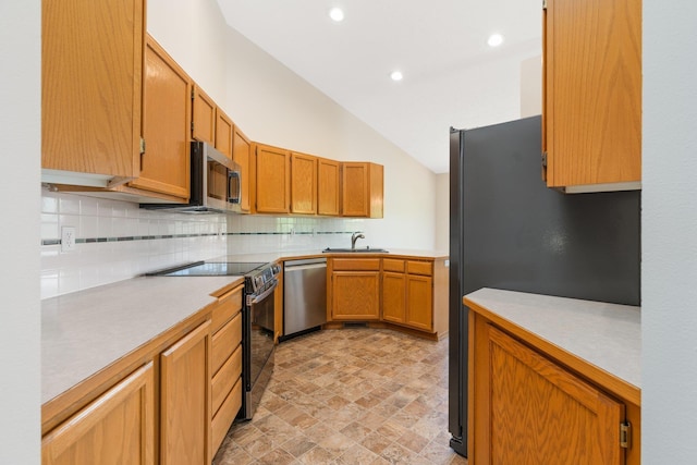 2106 E Turnberry Ln, Spokane, WA 99223 - kitchen featuring appliances with stainless steel finishes, tasteful backsplash, light countertops, stone finish floors, and recessed lighting
