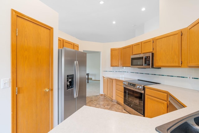 2106 E Turnberry Ln, Spokane, WA 99223 - kitchen featuring appliances with stainless steel finishes, light countertops, backsplash, and recessed lighting
