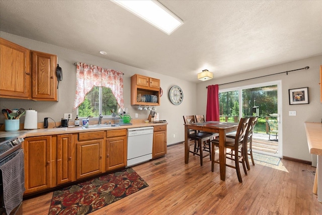1481 Northshore Diamond Lake Rd, Newport, WA 99156 - kitchen with white dishwasher, electric range, plenty of natural light, light wood finished floors, and a textured ceiling