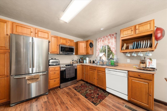 1481 Northshore Diamond Lake Rd, Newport, WA 99156 - kitchen with stainless steel appliances, dark wood-style flooring, and light countertops