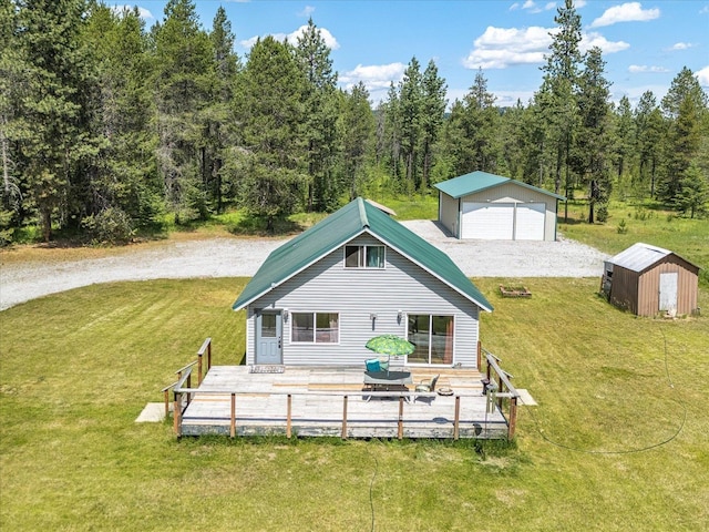 1481 Northshore Diamond Lake Rd, Newport, WA 99156 - back of house featuring a lawn, a garage, a view of trees, and a shed