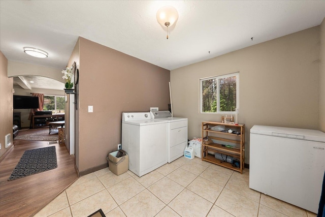 1481 Northshore Diamond Lake Rd, Newport, WA 99156 - washroom featuring independent washer and dryer, arched walkways, and light tile patterned floors