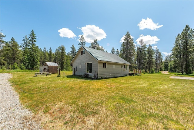 1481 Northshore Diamond Lake Rd, Newport, WA 99156 - view of side of property featuring a lawn, a metal roof, and a storage unit