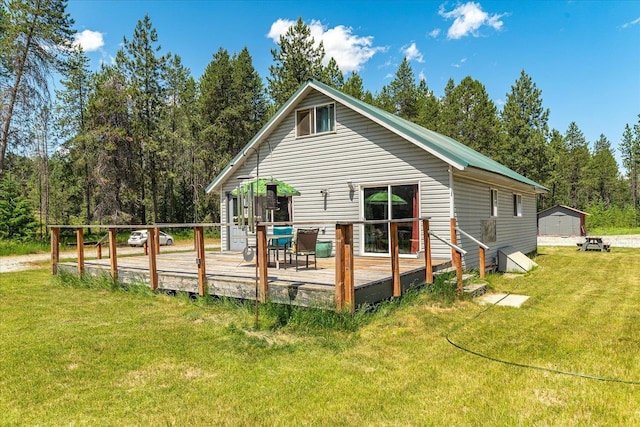 1481 Northshore Diamond Lake Rd, Newport, WA 99156 - back of house with a deck, a lawn, and a storage unit