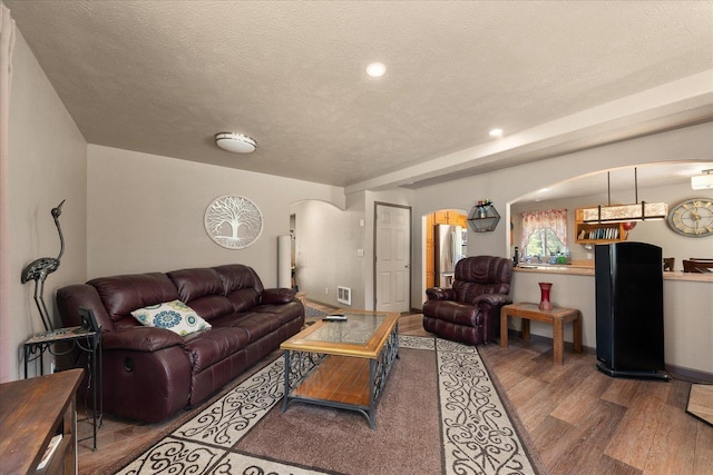 1481 Northshore Diamond Lake Rd, Newport, WA 99156 - living area with arched walkways, wood finished floors, a textured ceiling, and recessed lighting