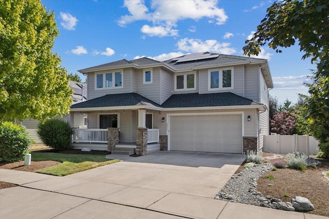 4213 S Cook St, Spokane, WA 99223 - view of front facade with a porch, driveway, roof mounted solar panels, a garage, and stone siding