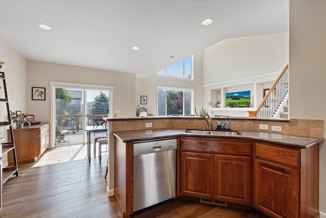 4213 S Cook St, Spokane, WA 99223 - kitchen featuring stainless steel dishwasher, plenty of natural light, brown cabinets, dark wood-style floors, and vaulted ceiling