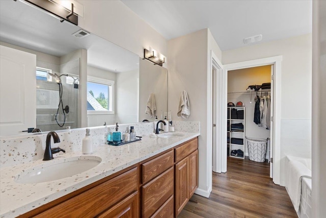 4213 S Cook St, Spokane, WA 99223 - full bath featuring a shower stall, double vanity, a spacious closet, wood finished floors, and a bath