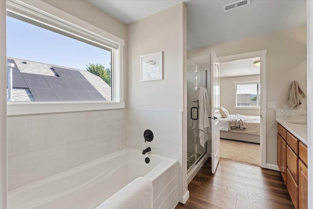 4213 S Cook St, Spokane, WA 99223 - full bathroom with wood finished floors, a bath, a stall shower, vanity, and connected bathroom