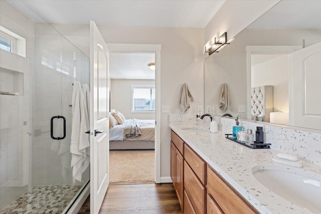 4213 S Cook St, Spokane, WA 99223 - ensuite bathroom featuring double vanity, wood finished floors, and a stall shower