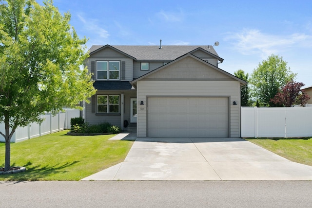1248 W Staples Rd, Post Falls, ID 83854 - traditional-style house featuring an attached garage, driveway, and a shingled roof