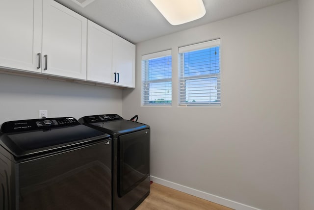 1248 W Staples Rd, Post Falls, ID 83854 - laundry room with cabinet space, washer and dryer, and light wood finished floors