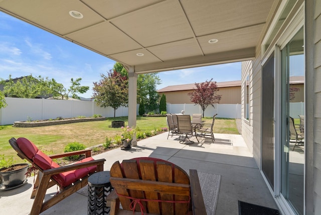 1248 W Staples Rd, Post Falls, ID 83854 - fenced backyard with a patio and outdoor dining space