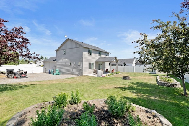 1248 W Staples Rd, Post Falls, ID 83854 - rear view of house featuring a fenced backyard, an outdoor fire pit, and a patio