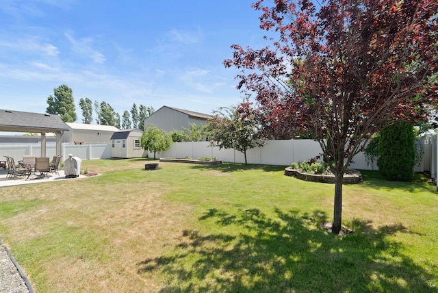 1248 W Staples Rd, Post Falls, ID 83854 - fenced backyard with a storage unit and a patio area