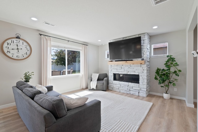 1248 W Staples Rd, Post Falls, ID 83854 - living area featuring light wood-style floors, a stone fireplace, and recessed lighting