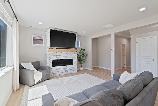 1248 W Staples Rd, Post Falls, ID 83854 - living area featuring light wood-style floors, a fireplace, and recessed lighting
