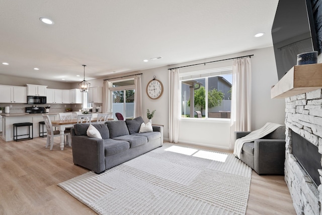 1248 W Staples Rd, Post Falls, ID 83854 - living room with a fireplace, light wood-style floors, and recessed lighting