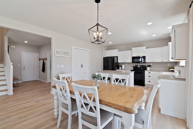 1248 W Staples Rd, Post Falls, ID 83854 - dining room featuring stairway, light wood-style flooring, a chandelier, and recessed lighting