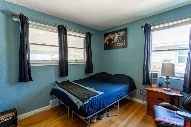 5711 N Ash St, Spokane, WA 99205 - bedroom featuring wood finished floors and a textured wall