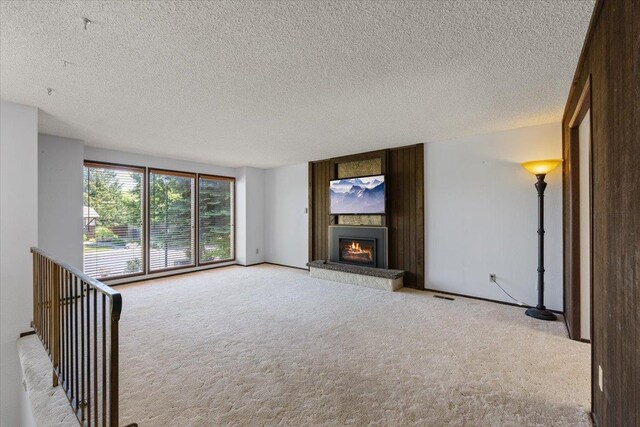 3810 S Moffitt Rd, Spokane Valley, WA 99206 - unfurnished living room featuring light colored carpet, a fireplace, and a textured ceiling