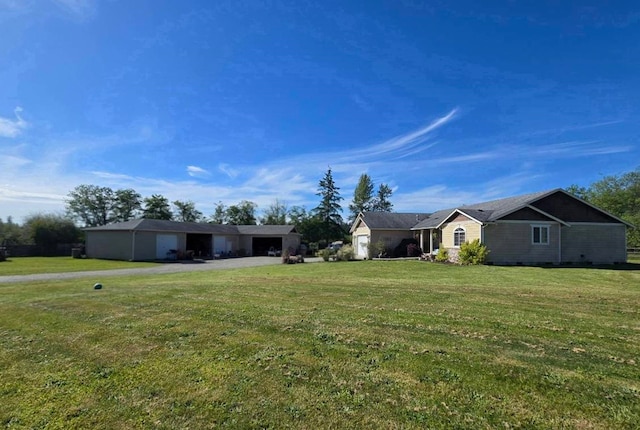6321 310th St NW Stanwood, Unit Stanwood, WA 98292 - view of grassy yard with a garage