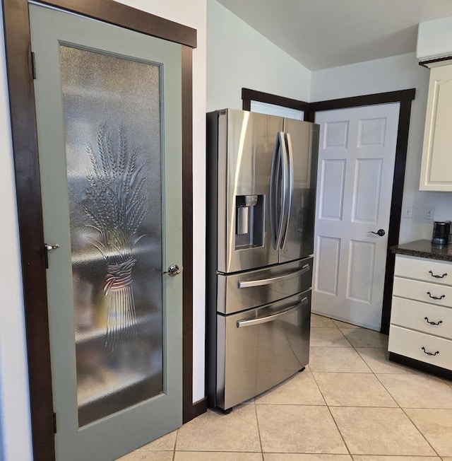 6321 310th St NW Stanwood, Unit Stanwood, WA 98292 - kitchen with stainless steel refrigerator with ice dispenser, white cabinetry, light tile patterned floors, a wall mounted air conditioner, and dark stone countertops