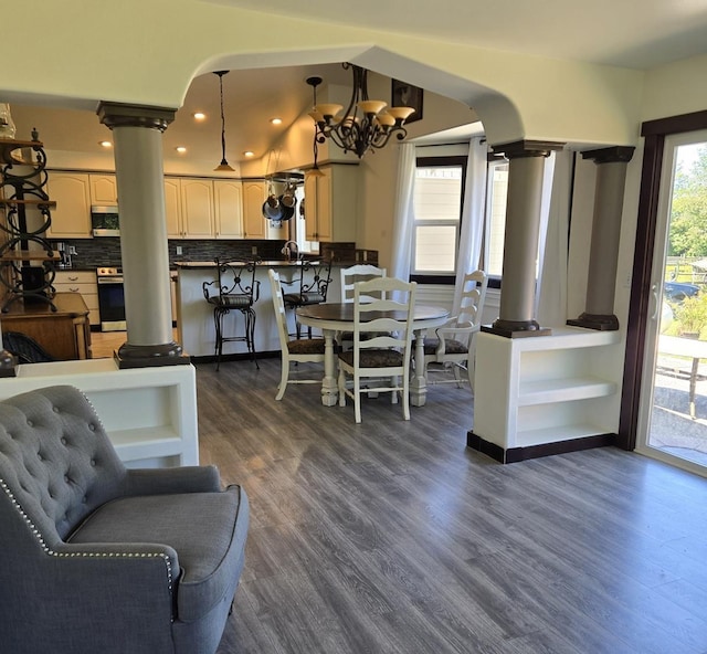 6321 310th St NW Stanwood, Unit Stanwood, WA 98292 - living area with decorative columns, dark wood-style floors, arched walkways, a chandelier, and recessed lighting