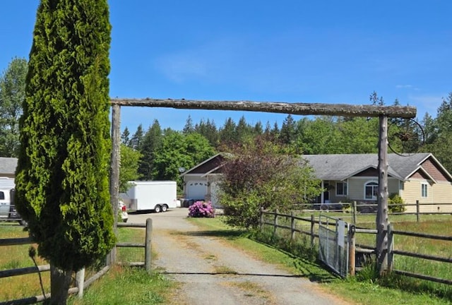 6321 310th St NW Stanwood, Unit Stanwood, WA 98292 - view of property hidden behind natural elements featuring driveway and a garage