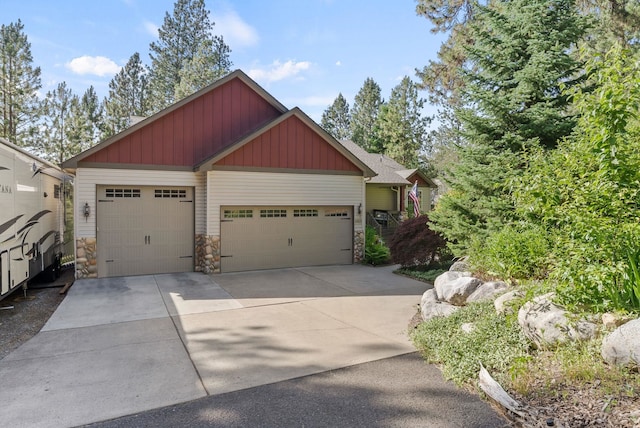 4812 S Wildwood Ln, Spokane, WA 99206 - craftsman house featuring stone siding, board and batten siding, driveway, and a garage