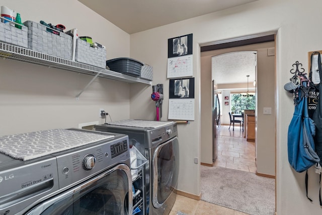 4812 S Wildwood Ln, Spokane, WA 99206 - laundry room featuring washer and clothes dryer, light colored carpet, and light tile patterned floors