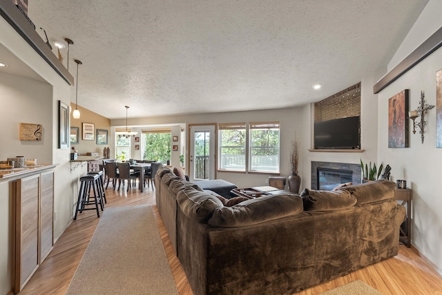 4812 S Wildwood Ln, Spokane, WA 99206 - living area with a textured ceiling, a tiled fireplace, wood finished floors, and recessed lighting
