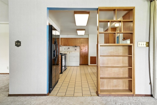 14807 E Broadway Ave, Spokane Valley, WA 99216 - kitchen with washing machine and clothes dryer, black refrigerator with ice dispenser, electric range, and light colored carpet
