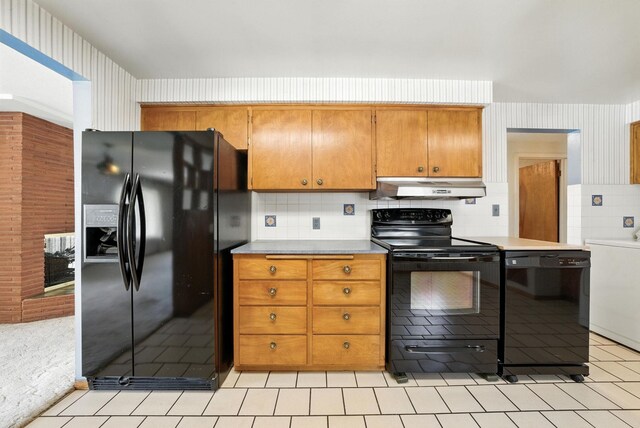 14807 E Broadway Ave, Spokane Valley, WA 99216 - kitchen with black appliances, under cabinet range hood, light countertops, and tasteful backsplash