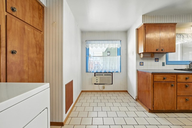 14807 E Broadway Ave, Spokane Valley, WA 99216 - kitchen with brown cabinets, wallpapered walls, cooling unit, and washer / clothes dryer
