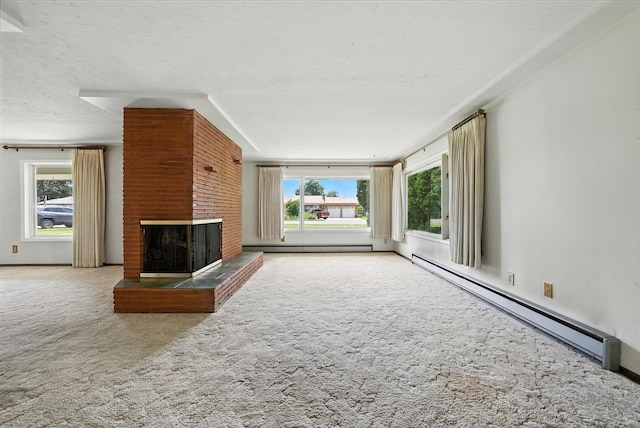 14807 E Broadway Ave, Spokane Valley, WA 99216 - unfurnished living room with a baseboard radiator, carpet floors, and a fireplace