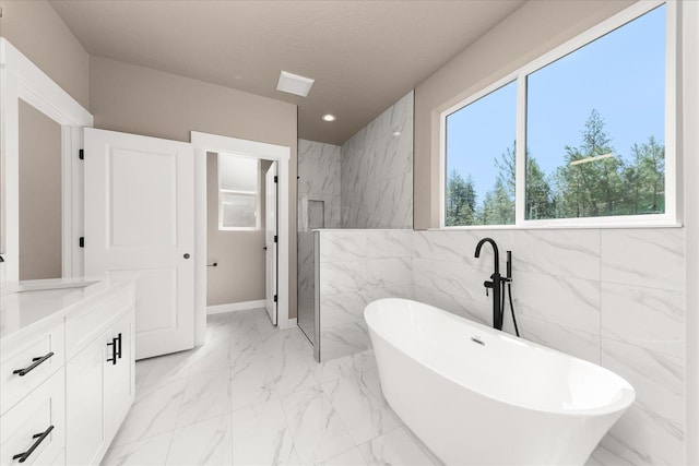 6571 Kate Dr, Nine Mile Falls, WA 99206 - full bathroom featuring tile walls, a freestanding bath, marble look tile flooring, vanity, and a marble finish shower