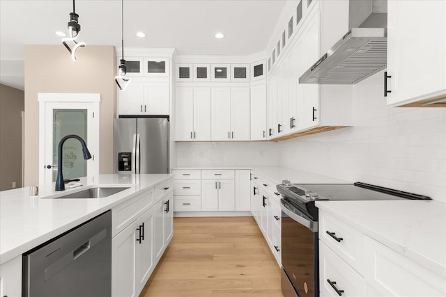 6571 Kate Dr, Nine Mile Falls, WA 99206 - kitchen with exhaust hood, appliances with stainless steel finishes, hanging light fixtures, tasteful backsplash, and white cabinetry