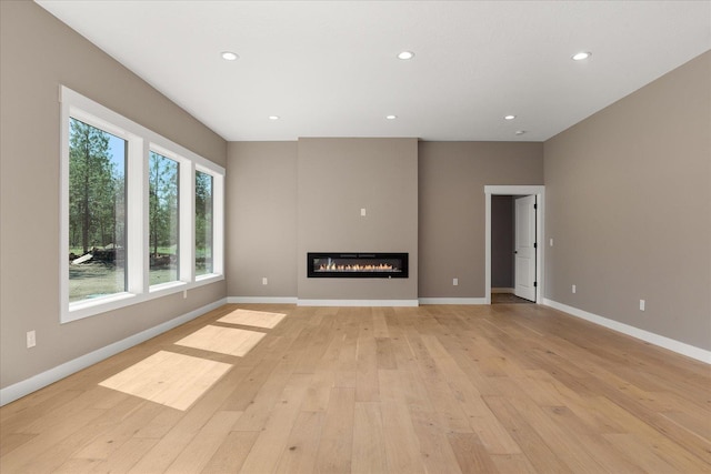 6571 Kate Dr, Nine Mile Falls, WA 99206 - unfurnished living room with light wood-style flooring, recessed lighting, and a glass covered fireplace