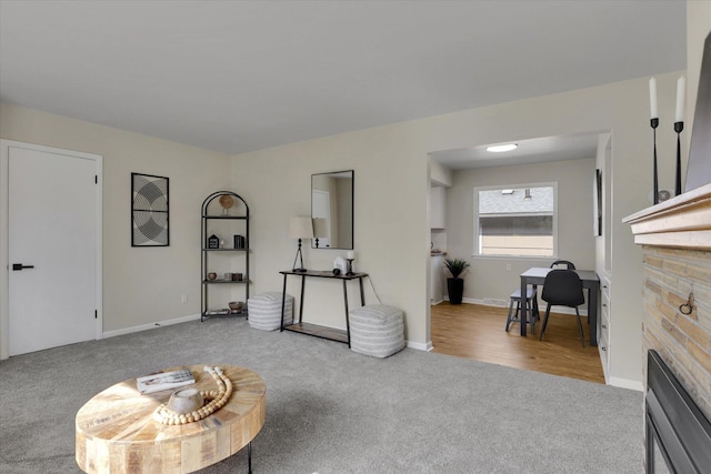 1406 S Cedar St Unit 1408, Spokane, WA 99203 - carpeted living area with a stone fireplace and baseboards