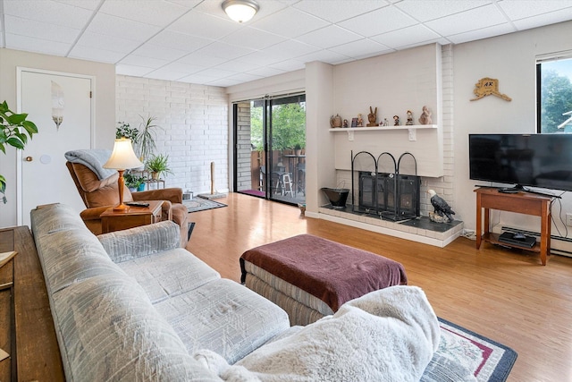 1716 N Pettet Dr Apt 2, Spokane, WA 99205 - living area featuring plenty of natural light, wood finished floors, a paneled ceiling, and a fireplace