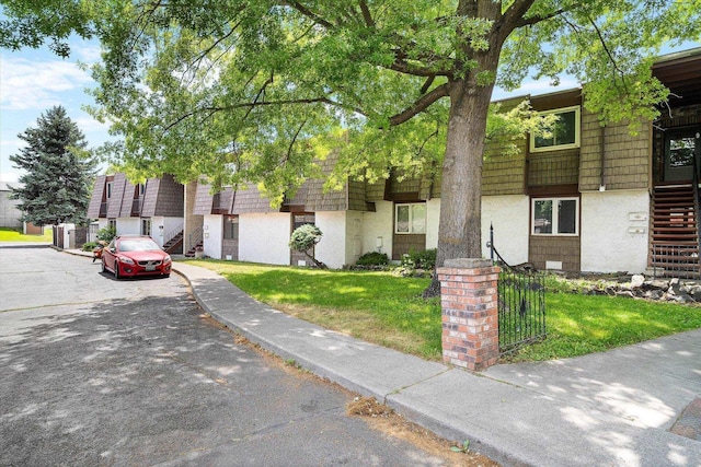 1716 N Pettet Dr Apt 2, Spokane, WA 99205 - multi unit property featuring stairway, mansard roof, a front yard, and stucco siding