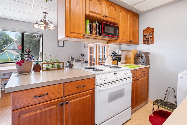 1716 N Pettet Dr Apt 2, Spokane, WA 99205 - kitchen featuring electric stove, black microwave, a drop ceiling, a chandelier, and light countertops